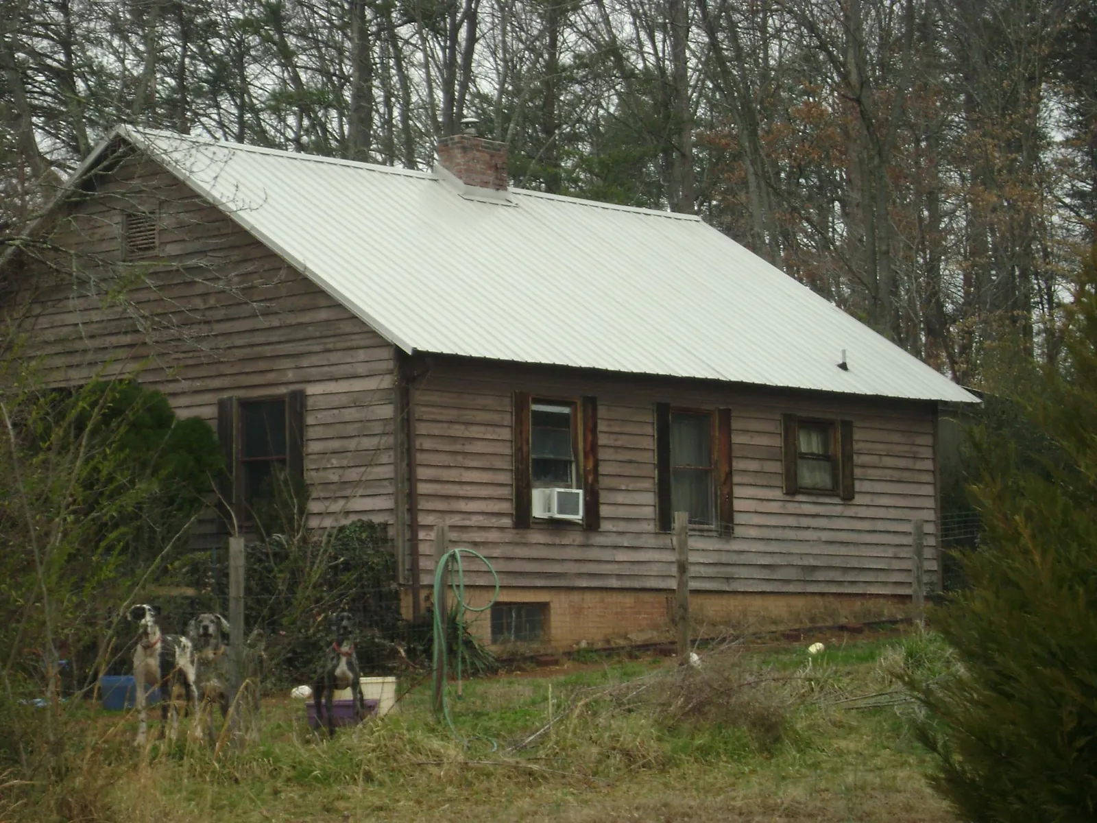 White metal roof on an old wood sided farmhouse, from a Metal Roof Installation job in Elysburg